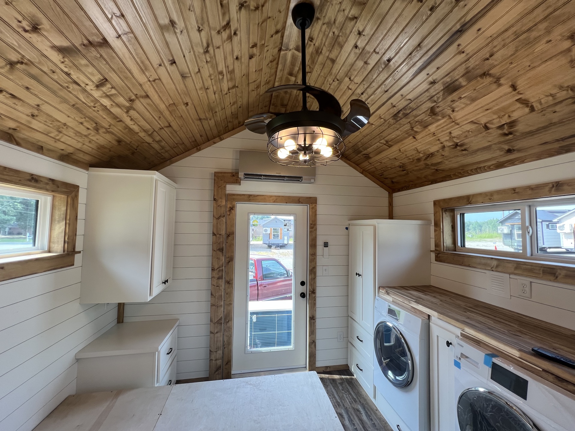 Bedroom with platform bed, storage and full-size laundry